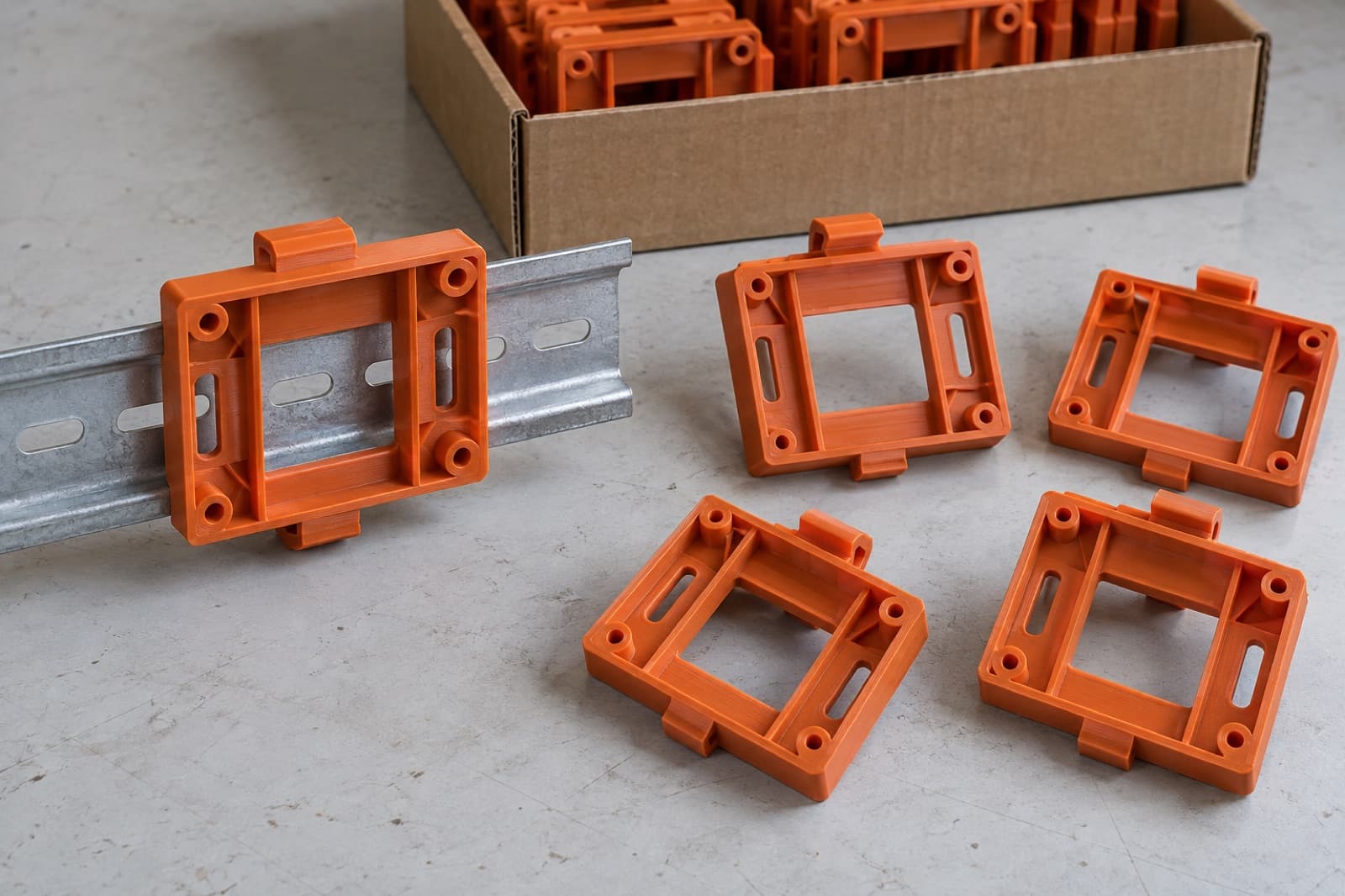3D printed DIN-rail carriers clipped onto a length of steel rail