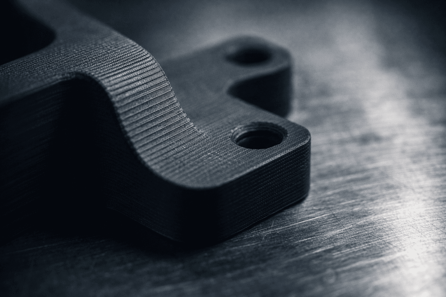 Macro view of a 3D printed CAD-designed bracket showing surface detail