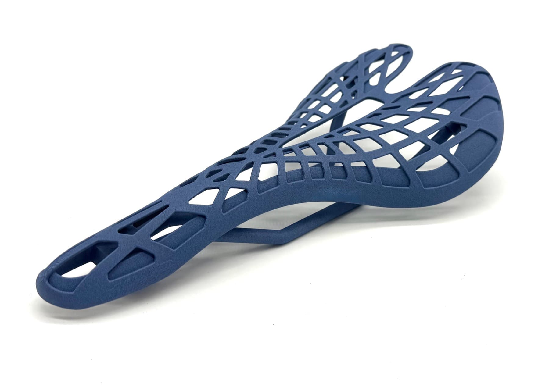 Navy blue 3D printed bicycle saddle with an organic Voronoi-style lattice structure — a generative-design output modeled and printed end-to-end by TAKT 3D