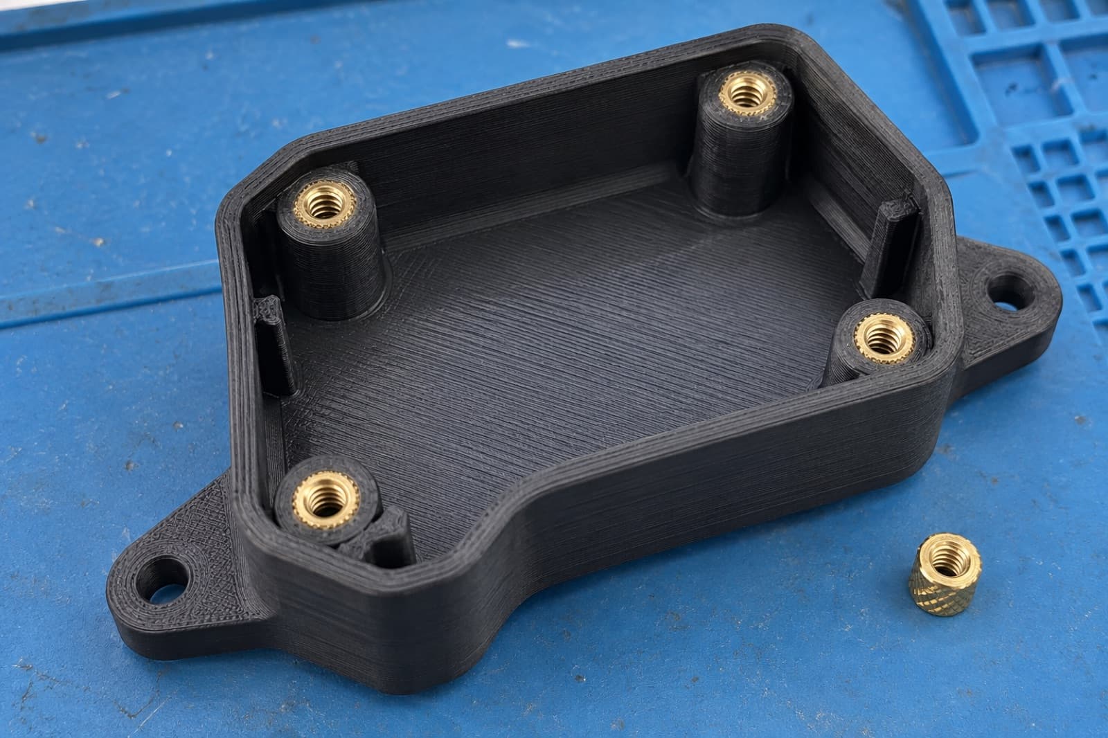 Brass heat-set inserts installed in a 3D printed electronics enclosure