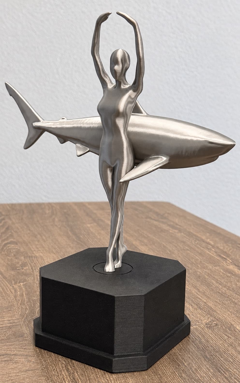 Metallic-finish 3D printed trophy of a dancer and shark on a black printed base, hand-finished as a presentation piece