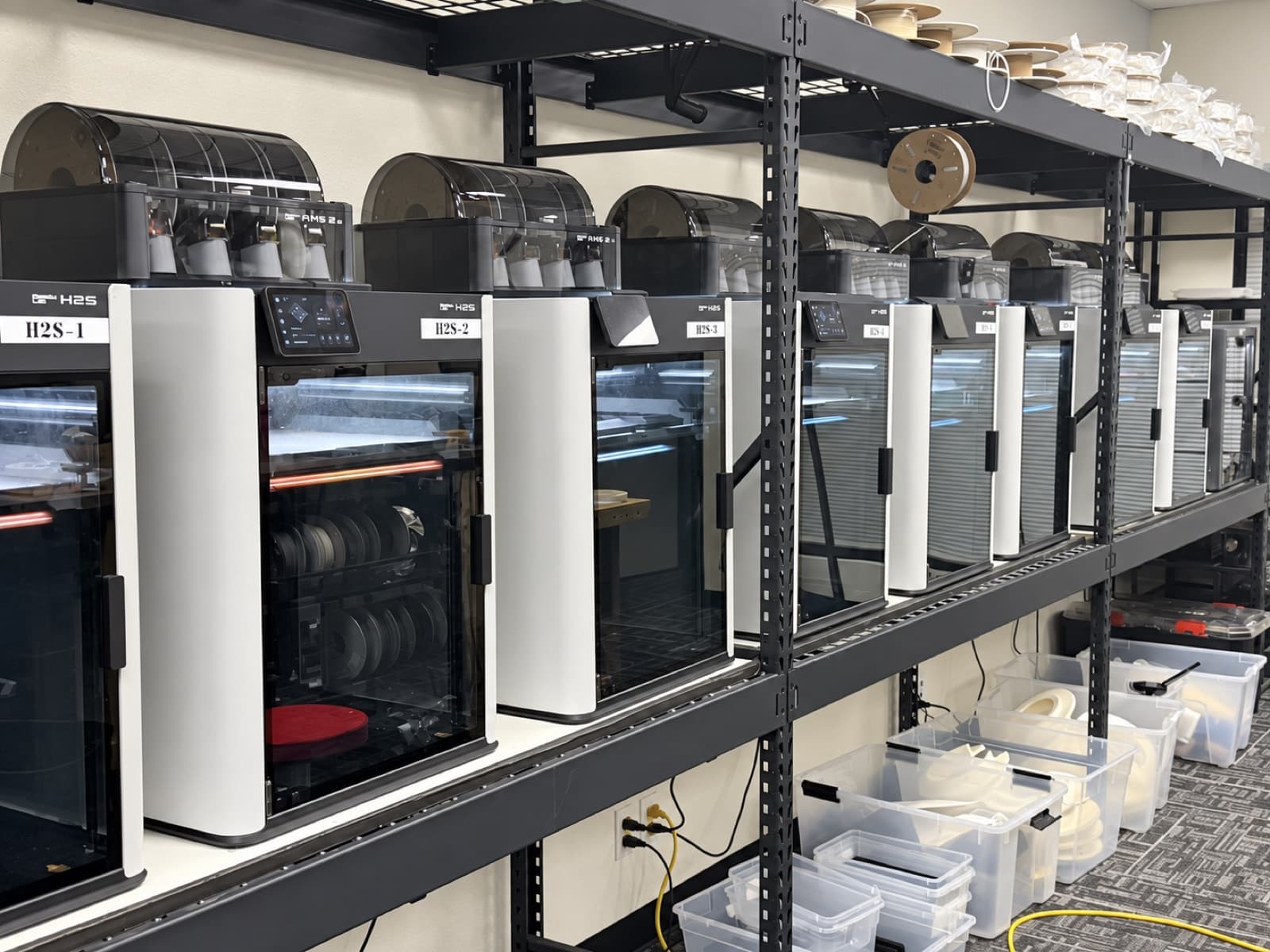 The TAKT 3D production floor in San Diego — a row of enclosed FDM printers, the shop behind every service