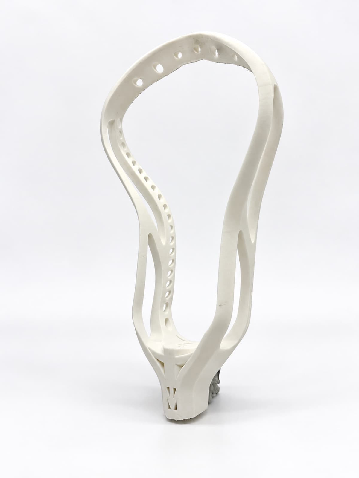 A white 3D printed lacrosse head prototype standing upright on a white studio sweep